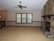 A cozy living room featuring a stone fireplace, carpet, three windows and vintage wall paper at 4187 Alaina Cir, Austell, GA 30106
