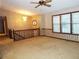 View of carpeted living room with chandelier, three windows, staircase and vintage wall paper at 4187 Alaina Cir, Austell, GA 30106