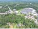 Aerial view of a home and wooded lot near retail and roads with ample parking at 8035 Rockbridge Rd, Lithonia, GA 30058