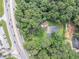 Aerial view of a home with mature trees near a road with plenty of parking at 8035 Rockbridge Rd, Lithonia, GA 30058