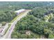 Aerial view of treed lot near highway and commercial business area at 8035 Rockbridge Rd, Lithonia, GA 30058