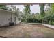The brick house is backed by a paved yard with trees in the background at 8035 Rockbridge Rd, Lithonia, GA 30058