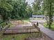 Large backyard with a wooden deck, partially fenced and surrounded by mature trees at 8035 Rockbridge Rd, Lithonia, GA 30058