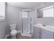 Bathroom with a shower and a grey cabinet and sink at 8035 Rockbridge Rd, Lithonia, GA 30058