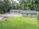 Home exterior with large yard at 8035 Rockbridge Rd, Lithonia, GA 30058