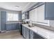 Bright kitchen featuring grey cabinets, stainless steel appliances and granite countertops at 8035 Rockbridge Rd, Lithonia, GA 30058