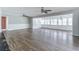 Spacious living room featuring laminate flooring, neutral wall colors, and a seamless transition into dining area at 8035 Rockbridge Rd, Lithonia, GA 30058