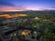 Night aerial view of a grand estate illuminated against the twilight sky, highlighting the home and landscape at 1310 Settles Rd, Suwanee, GA 30024