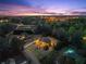 Aerial dusk view of the illuminated property and its neighborhood location at 1310 Settles Rd, Suwanee, GA 30024