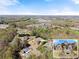 Aerial view of the property showcasing its large lot and proximity to wooded areas at 1310 Settles Rd, Suwanee, GA 30024