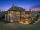 Exterior back view of two-story brick home showcasing a large backyard, patio, and spiral staircase at 1310 Settles Rd, Suwanee, GA 30024