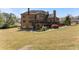 Expansive backyard featuring a brick home with a deck and a spiral staircase at 1310 Settles Rd, Suwanee, GA 30024