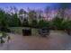The brick patio overlooks a fenced backyard with green grass and mature trees, offering privacy and space at 1310 Settles Rd, Suwanee, GA 30024