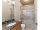Bathroom featuring granite countertop, tile backsplash, shower with glass door, and tile flooring at 1310 Settles Rd, Suwanee, GA 30024