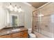 Bathroom featuring granite countertop, shower with glass door, tile flooring, and vanity with lights at 1310 Settles Rd, Suwanee, GA 30024
