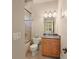Compact bathroom features a combined shower and tub, granite countertop, and light wood cabinetry at 1310 Settles Rd, Suwanee, GA 30024