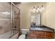 Bathroom featuring granite countertop, shower with glass door, tile flooring, and vanity with lights at 1310 Settles Rd, Suwanee, GA 30024