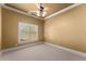 Bedroom with neutral carpet, ceiling fan, and a large window at 1310 Settles Rd, Suwanee, GA 30024