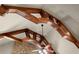 Unique ceiling with exposed beams and an ornate ceiling fan over a stone fireplace creates architectural interest at 1310 Settles Rd, Suwanee, GA 30024