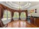 Dining area features a chandelier, windows, and a built-in bar at 1310 Settles Rd, Suwanee, GA 30024