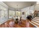 Bright breakfast area with a glass top table, a view of the staircase, and surrounded by large windows at 1310 Settles Rd, Suwanee, GA 30024