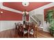 Elegant dining room with a dark wood table, seating for eight, hardwood floors and an ornate chandelier at 1310 Settles Rd, Suwanee, GA 30024