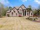 Elegant stone home with manicured lawn, water feature and palm trees at 1310 Settles Rd, Suwanee, GA 30024