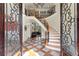 Grand foyer with curved staircase, wrought iron railings, and patterned tile flooring at 1310 Settles Rd, Suwanee, GA 30024