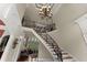 Grand foyer staircase with intricate iron railings leading to a bright, open living space and high ceilings at 1310 Settles Rd, Suwanee, GA 30024