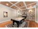 A game room complete with billiard table and stone fireplace creates a cozy entertaining space at 1310 Settles Rd, Suwanee, GA 30024