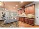 Kitchen area with a granite counter, cooktop and custom cabinets at 1310 Settles Rd, Suwanee, GA 30024