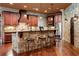 Spacious kitchen with a stone accent wall, wooden cabinets, large island, and seating for entertainment at 1310 Settles Rd, Suwanee, GA 30024