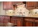 Chef's kitchen with custom cabinetry, gas cooktop, and elegant backsplash perfect for culinary enthusiasts at 1310 Settles Rd, Suwanee, GA 30024
