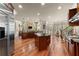 Expansive kitchen features stainless appliances, granite countertops, dual islands, breakfast area, and hardwood floors at 1310 Settles Rd, Suwanee, GA 30024