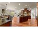 Large kitchen featuring hardwood floors, stainless appliances, granite countertops, custom backsplash and abundant storage at 1310 Settles Rd, Suwanee, GA 30024
