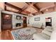 Cozy living room featuring a stone fireplace, hardwood floors, and coffered ceiling at 1310 Settles Rd, Suwanee, GA 30024