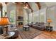 Inviting living room featuring stone fireplace, soaring ceilings, hardwood floors, and ample natural light at 1310 Settles Rd, Suwanee, GA 30024