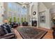 Spacious living room with a fireplace, hardwood floors, large windows, and coffered ceilings, creating a bright, airy ambiance at 1310 Settles Rd, Suwanee, GA 30024