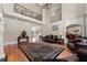 Open-concept living room with hardwood floors, high ceilings, large windows, and a staircase to upper level at 1310 Settles Rd, Suwanee, GA 30024
