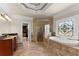 Main bathroom boasts a soaking tub, glass shower, and stained glass window at 1310 Settles Rd, Suwanee, GA 30024