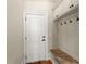 Mudroom with built-in bench, storage cabinets, hooks, and a convenient door to the exterior at 1310 Settles Rd, Suwanee, GA 30024