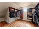 Walk-in closet with custom built-in shelving and hardwood floors at 1310 Settles Rd, Suwanee, GA 30024