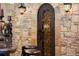 Custom iron door leading to a stone wine cellar at 1310 Settles Rd, Suwanee, GA 30024