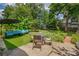 Outdoor patio with cozy lounge seating, dining table and lush backyard and garden area at 222 Winonna Dr, Decatur, GA 30030