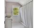 Bathroom with white tile, granite countertop, and a window at 222 Winonna Dr, Decatur, GA 30030