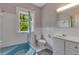 Bathroom features a blue bathtub, a window, and white tile walls at 222 Winonna Dr, Decatur, GA 30030