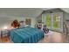 View of a bedroom with a sloped ceiling, large window, and drum set at 222 Winonna Dr, Decatur, GA 30030