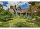 Charming two-story home with a gabled roof, brick chimney, and lush landscaping in a suburban setting at 222 Winonna Dr, Decatur, GA 30030