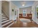 Welcoming foyer with hardwood floors, a built-in bench, and a staircase leading to the upper level at 222 Winonna Dr, Decatur, GA 30030
