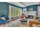 Inviting living room featuring a fireplace, built-in bookshelves, and large windows with sheer curtains at 222 Winonna Dr, Decatur, GA 30030